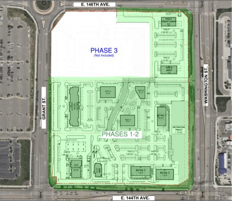 A birds-eye view of a proposed commercial development property that is largely dominated by parking spaces.